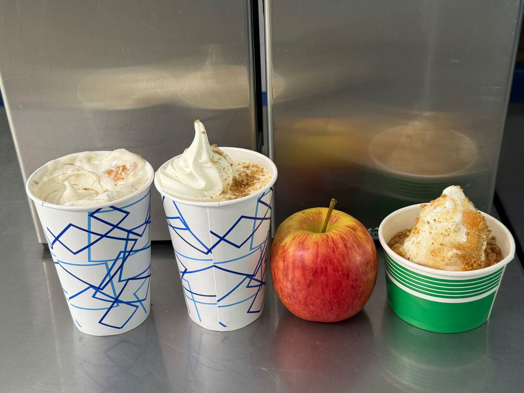 An apple beside Dairy Haven’s soft serve with apple topping and crumbs