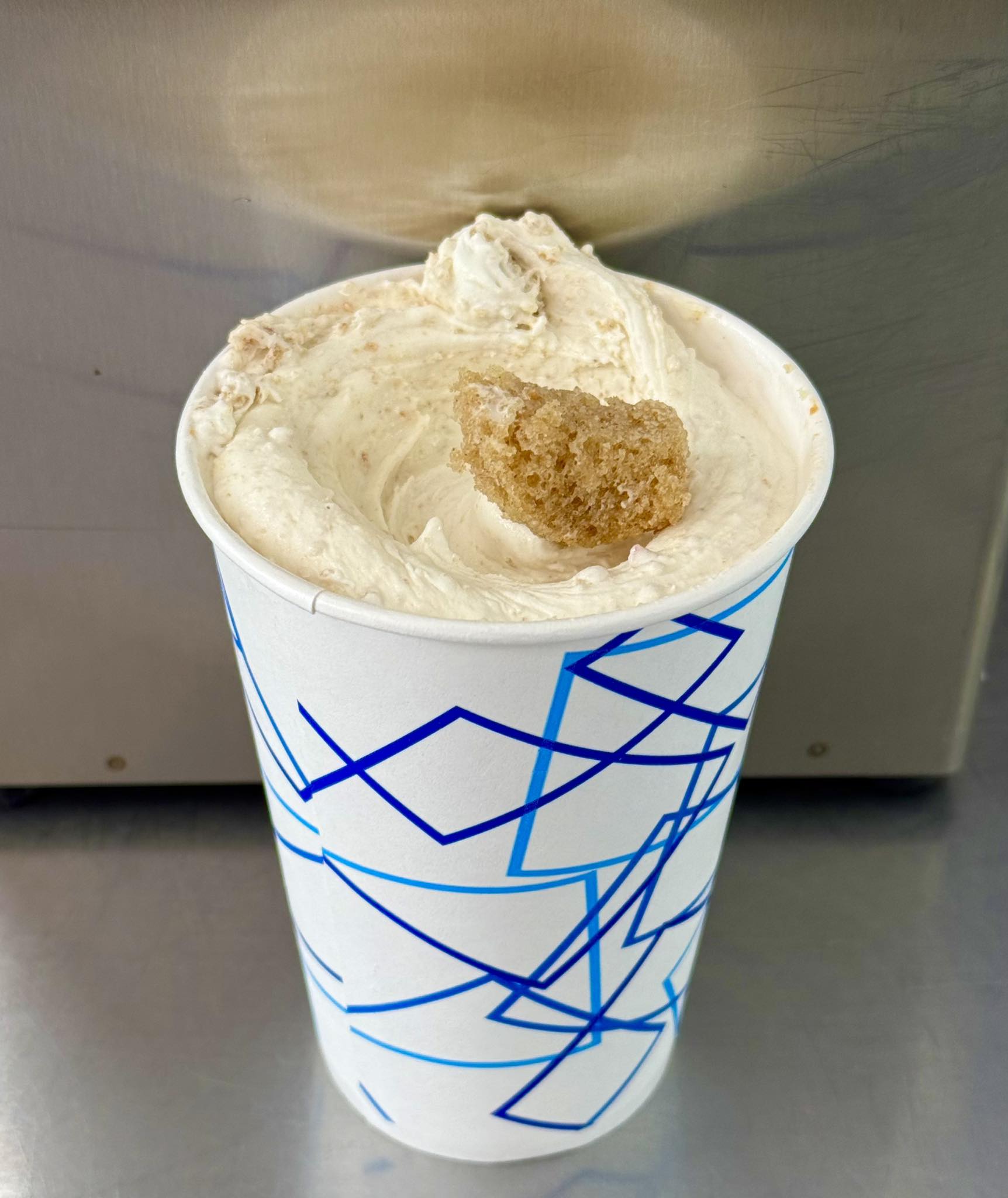 A thick Dairy Haven concrete in a blue-patterned paper cup