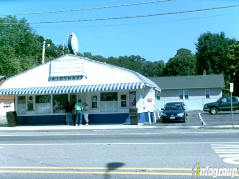 An older photograph of Dairy Haven’s white stand and blue-striped awning, with customers at the window